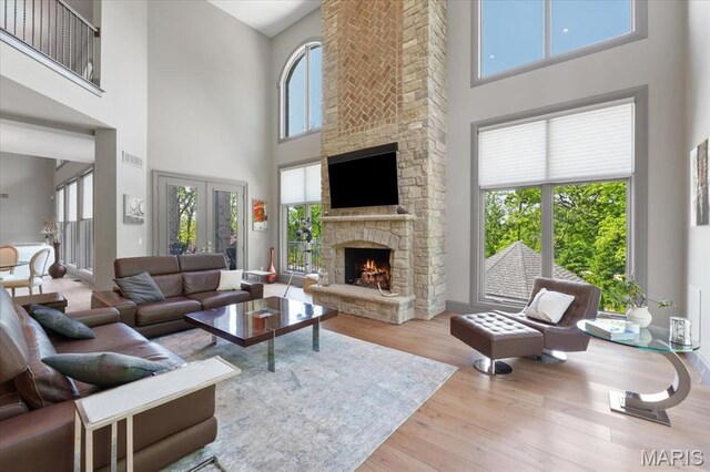 2535 S Lindbergh Blvd, Saint Louis, MO 63131 - living area featuring a high ceiling, a fireplace, wood finished floors, and french doors