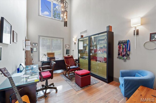 2535 S Lindbergh Blvd, Saint Louis, MO 63131 - office featuring wood finished floors, a high ceiling, and a chandelier