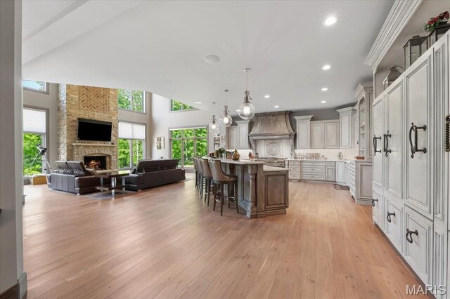 2535 S Lindbergh Blvd, Saint Louis, MO 63131 - kitchen with custom exhaust hood, open floor plan, a kitchen breakfast bar, healthy amount of natural light, and recessed lighting