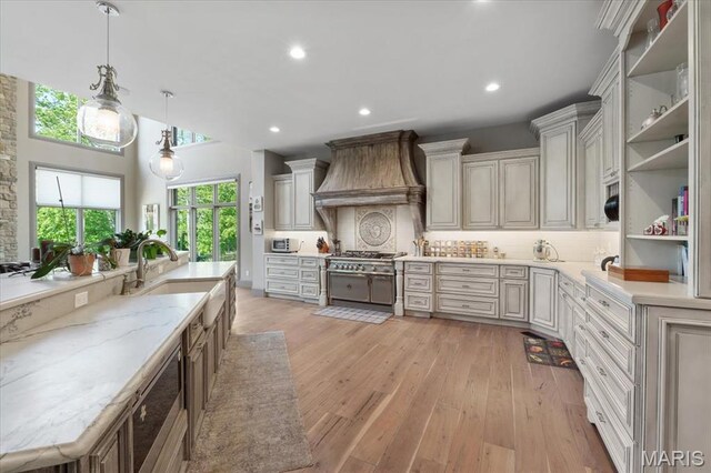 2535 S Lindbergh Blvd, Saint Louis, MO 63131 - kitchen with premium range hood, a sink, open shelves, decorative backsplash, and light wood-type flooring