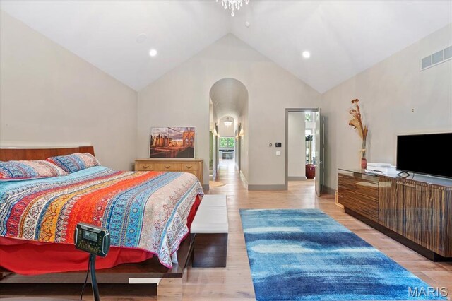 2535 S Lindbergh Blvd, Saint Louis, MO 63131 - bedroom with arched walkways, high vaulted ceiling, light wood-type flooring, recessed lighting, and baseboards