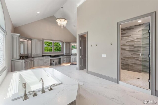 2535 S Lindbergh Blvd, Saint Louis, MO 63131 - kitchen with light marble finish floors, a chandelier, high vaulted ceiling, recessed lighting, and gray cabinetry