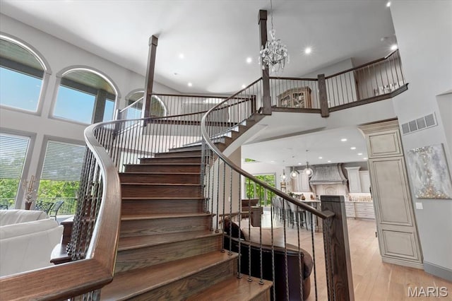 2535 S Lindbergh Blvd, Saint Louis, MO 63131 - staircase with a towering ceiling, wood finished floors, a chandelier, and recessed lighting