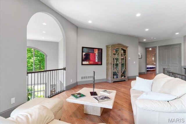2535 S Lindbergh Blvd, Saint Louis, MO 63131 - living room featuring recessed lighting, arched walkways, wood finished floors, and baseboards