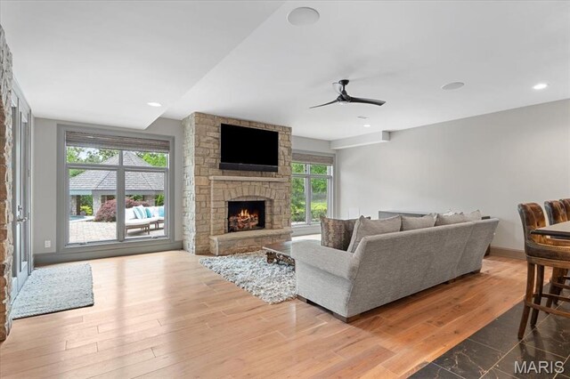2535 S Lindbergh Blvd, Saint Louis, MO 63131 - living area with a ceiling fan, a fireplace, wood finished floors, and baseboards