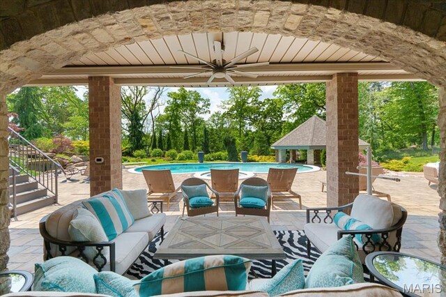 2535 S Lindbergh Blvd, Saint Louis, MO 63131 - view of patio featuring an outdoor hangout area, a ceiling fan, stairs, a gazebo, and an outdoor pool