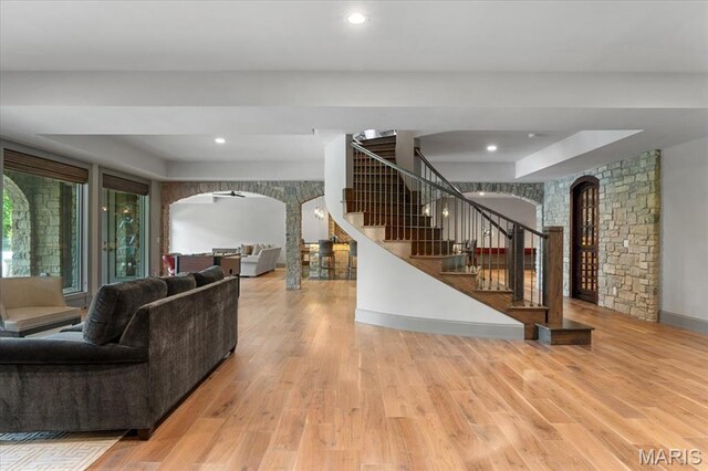 2535 S Lindbergh Blvd, Saint Louis, MO 63131 - living room featuring arched walkways, stairs, wood finished floors, and recessed lighting