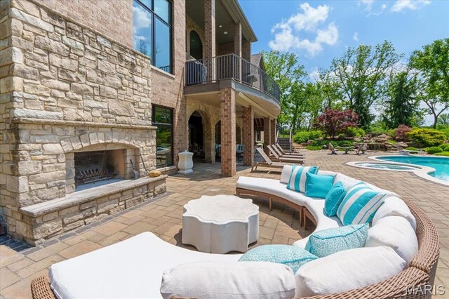 2535 S Lindbergh Blvd, Saint Louis, MO 63131 - view of patio featuring a balcony, an outdoor pool, and an outdoor living space with a fireplace