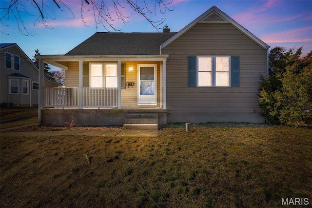 215 Virginia St, Saint Genevieve, MO 63670 - bungalow-style home featuring a porch, a lawn, a chimney, and a shingled roof