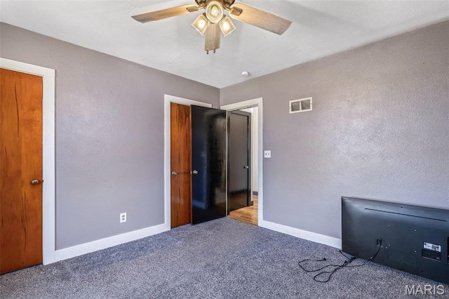 215 Virginia St, Saint Genevieve, MO 63670 - unfurnished bedroom featuring carpet flooring, a textured wall, and a ceiling fan