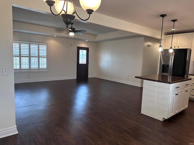 kitchen featuring stainless steel fridge with ice dispenser, dark countertops, baseboards, a ceiling fan, and white cabinets