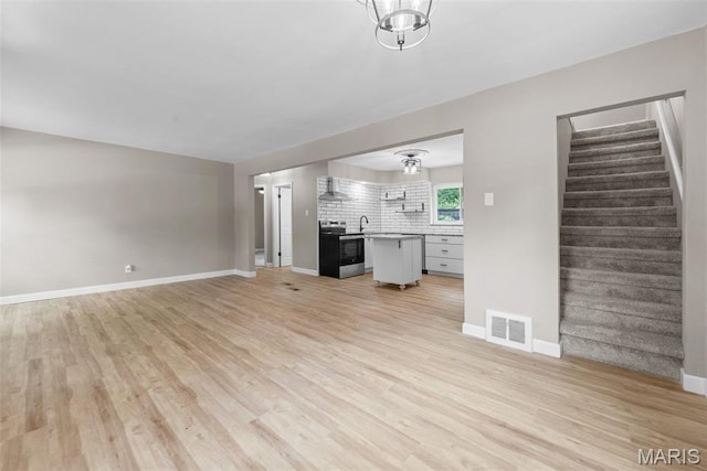1247 Charlane Ct, Saint Louis, MO 63119 - unfurnished living room with light wood-type flooring and stairs