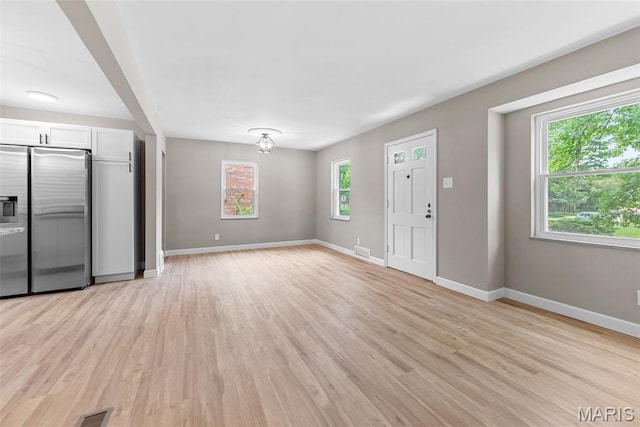 1247 Charlane Ct, Saint Louis, MO 63119 - unfurnished living room featuring light wood finished floors and baseboards