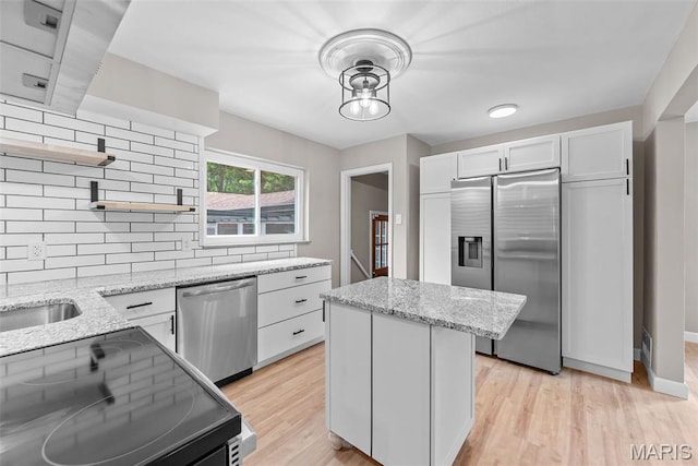1247 Charlane Ct, Saint Louis, MO 63119 - kitchen with stainless steel appliances, open shelves, tasteful backsplash, a center island, and white cabinets