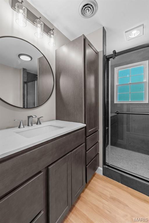 1247 Charlane Ct, Saint Louis, MO 63119 - bathroom with vanity, a stall shower, and wood finished floors