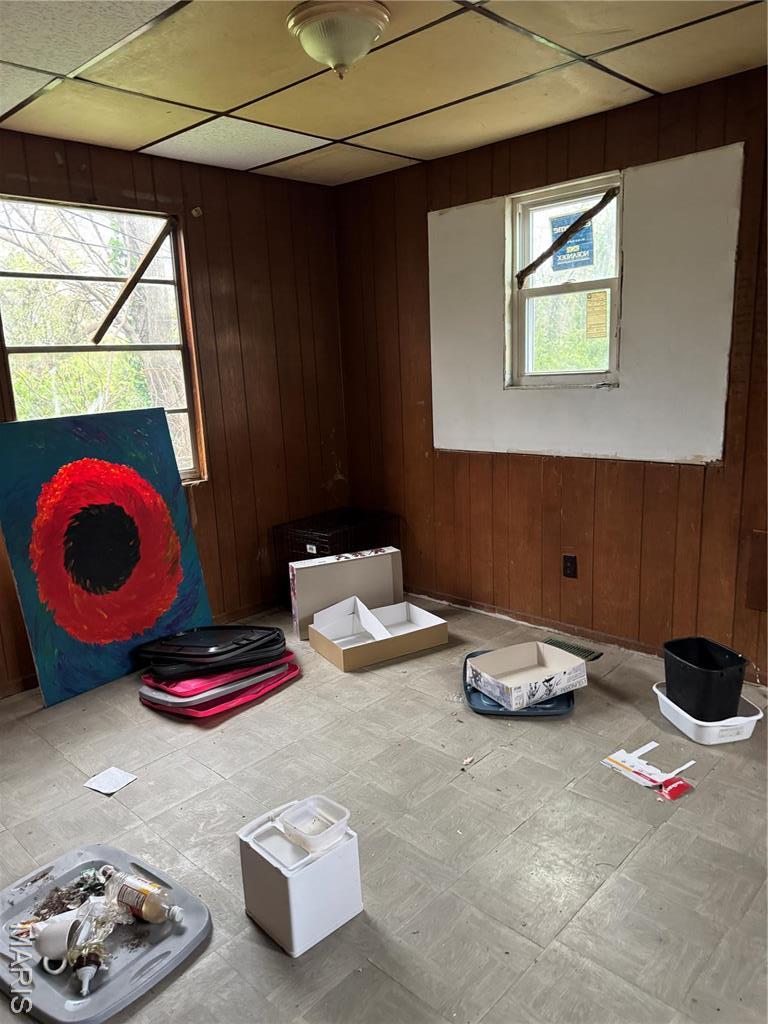 5119 Terry Ave, Saint Louis, MO 63115 - unfurnished room featuring wood walls and tile patterned floors