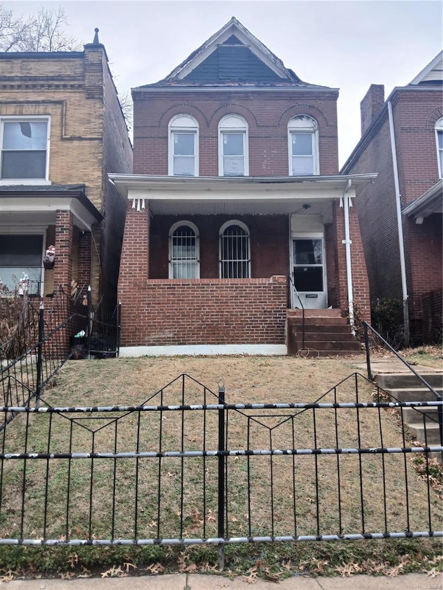 4741 Greer Ave, Saint Louis, MO 63115 - view of front of property with a porch, brick siding, and a fenced front yard