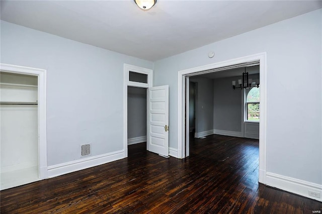 4220 Cleveland Ave, Saint Louis, MO 63110 - unfurnished bedroom featuring wood-type flooring, baseboards, and a chandelier