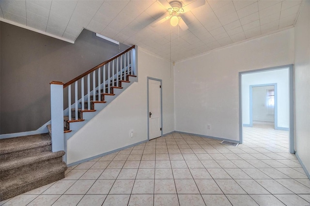 342 N Adams Ave, Lebanon, MO 65536 - unfurnished living room featuring ceiling fan, stairway, crown molding, and light tile patterned floors