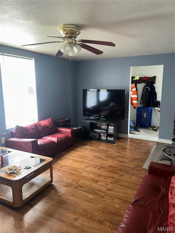 618 Church St, Hannibal, MO 63401 - living room featuring a ceiling fan, wood finished floors, and a textured ceiling