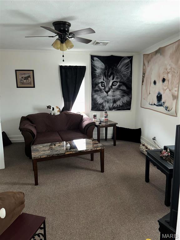 618 Church St, Hannibal, MO 63401 - carpeted living room featuring a ceiling fan and baseboards