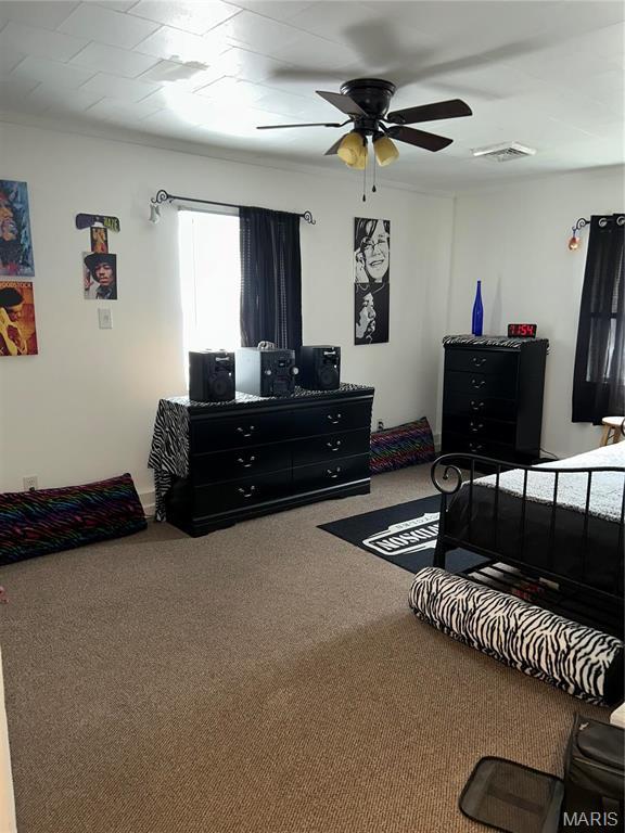 618 Church St, Hannibal, MO 63401 - carpeted bedroom featuring a ceiling fan