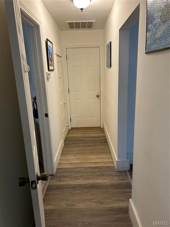 618 Church St, Hannibal, MO 63401 - corridor with dark wood-style floors and baseboards