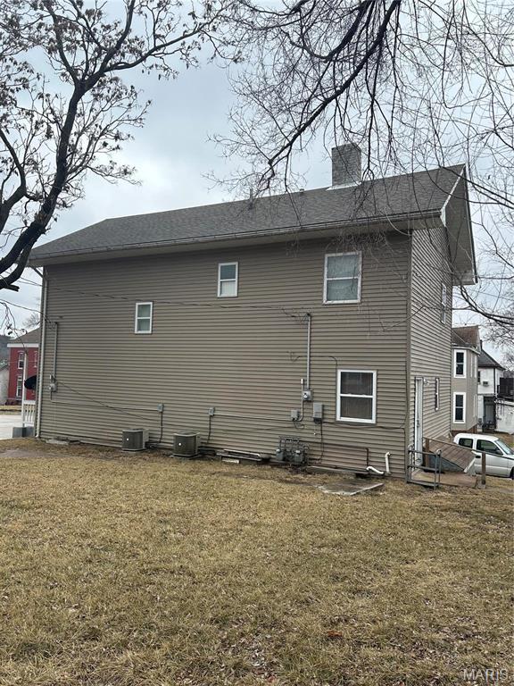 618 Church St, Hannibal, MO 63401 - view of home's exterior featuring a yard and a chimney
