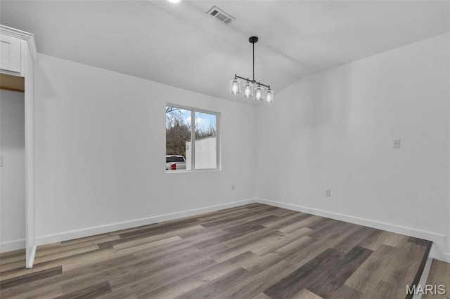 18211 State Highway J, Malden, MO 63863 - unfurnished dining area featuring vaulted ceiling, wood finished floors, baseboards, and a chandelier