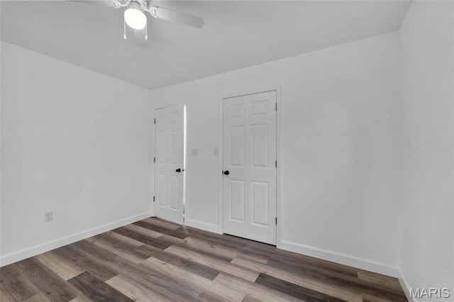 18211 State Highway J, Malden, MO 63863 - unfurnished bedroom featuring wood finished floors, baseboards, and ceiling fan