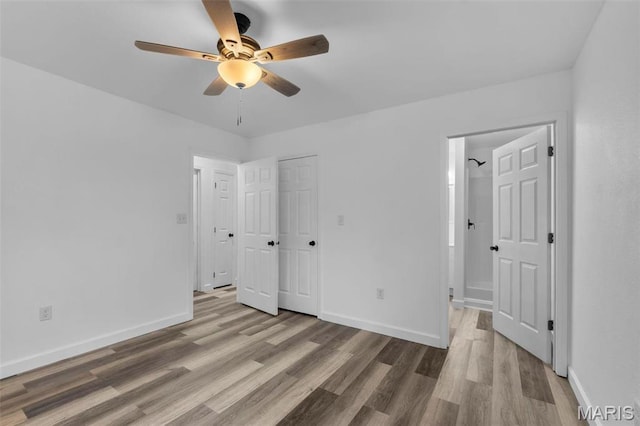 18211 State Highway J, Malden, MO 63863 - unfurnished bedroom featuring wood finished floors, baseboards, ensuite bathroom, and ceiling fan