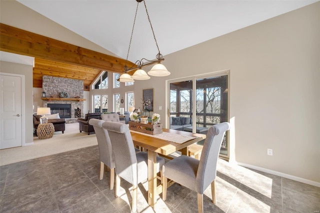 12054 Anthonies Mill Rd, Bourbon, MO 65441 - carpeted dining space featuring a fireplace, baseboards, beam ceiling, high vaulted ceiling, and tile patterned floors