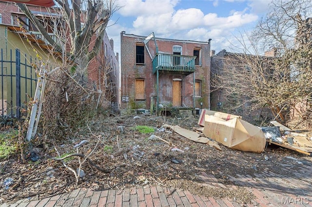5943 Page Blvd, Saint Louis, MO 63112 - back of house featuring a balcony and brick siding