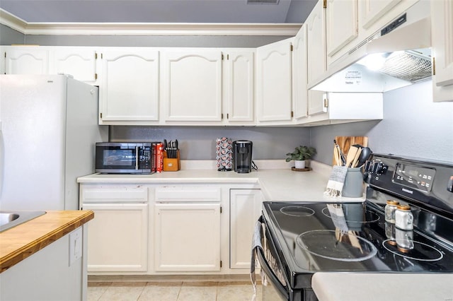 kitchen with black range with electric cooktop, under cabinet range hood, stainless steel microwave, freestanding refrigerator, and white cabinetry