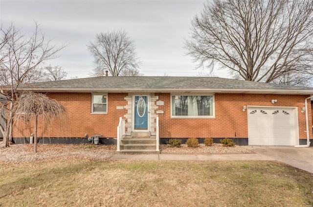2571 Boyle Ave, Granite City, IL 62040 - view of front of house featuring entry steps, a garage, brick siding, driveway, and roof with shingles