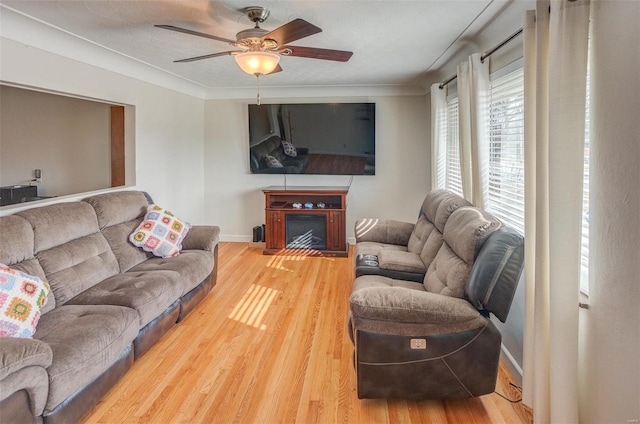 2571 Boyle Ave, Granite City, IL 62040 - living room featuring light wood-style flooring, ceiling fan, baseboards, and a fireplace