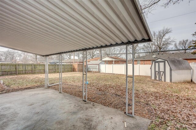 2571 Boyle Ave, Granite City, IL 62040 - fenced backyard featuring a storage unit, a patio, and an outbuilding