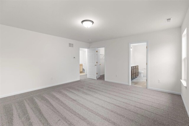 317 Winding Bluffs Ct, Fenton, MO 63026 - unfurnished bedroom with baseboards, light colored carpet, ensuite bathroom, a spacious closet, and a closet