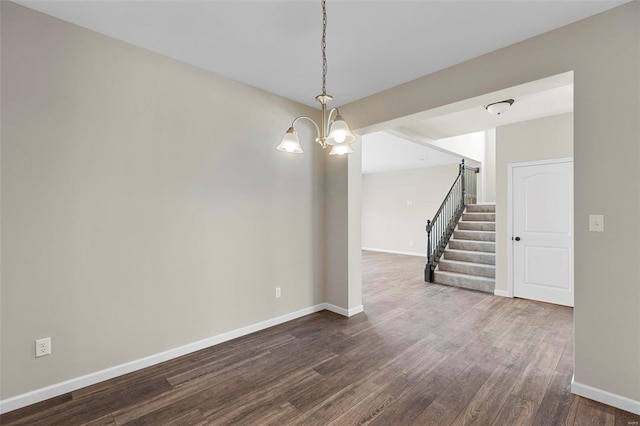 317 Winding Bluffs Ct, Fenton, MO 63026 - empty room featuring a chandelier, stairway, dark wood-style floors, and baseboards