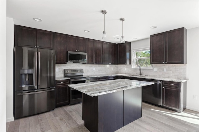 317 Winding Bluffs Ct, Fenton, MO 63026 - kitchen with appliances with stainless steel finishes, a sink, light wood-style floors, dark brown cabinetry, and recessed lighting