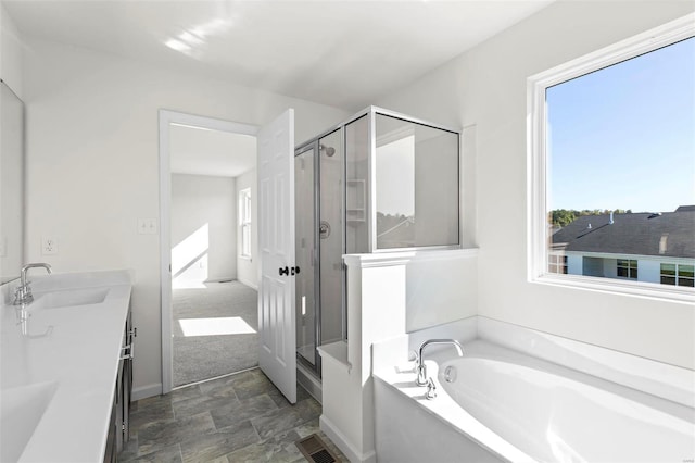 317 Winding Bluffs Ct, Fenton, MO 63026 - bathroom with plenty of natural light, a shower stall, a bath, and stone finish floors
