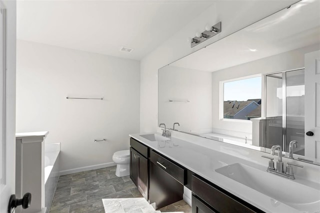 317 Winding Bluffs Ct, Fenton, MO 63026 - bathroom featuring baseboards, toilet, a shower stall, a garden tub, and double vanity
