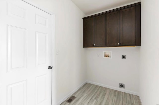 317 Winding Bluffs Ct, Fenton, MO 63026 - washroom featuring hookup for an electric dryer, washer hookup, cabinet space, and light wood-style flooring