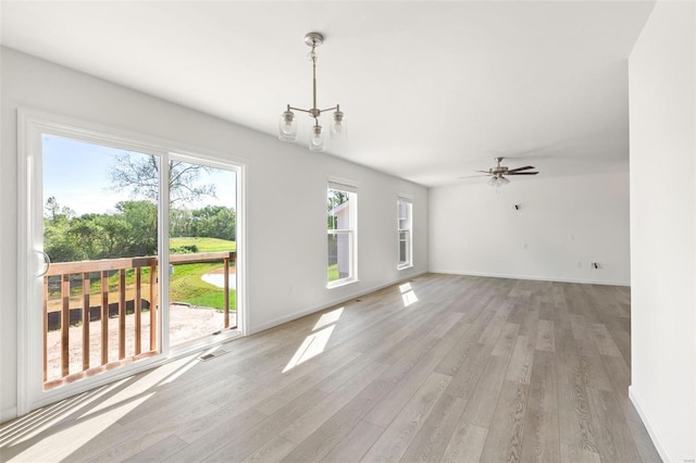 317 Winding Bluffs Ct, Fenton, MO 63026 - unfurnished dining area featuring plenty of natural light, light wood-style flooring, and baseboards