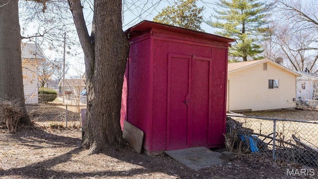 view of shed with fence