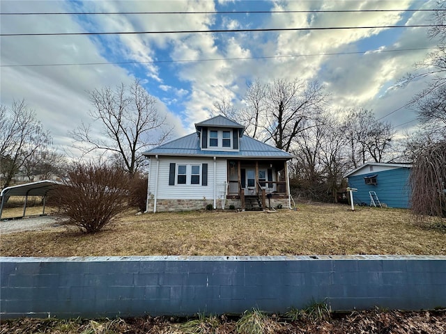 807 E 4th St, Salem, MO 65560 - view of front of house with covered porch, metal roof, a carport, and a front yard
