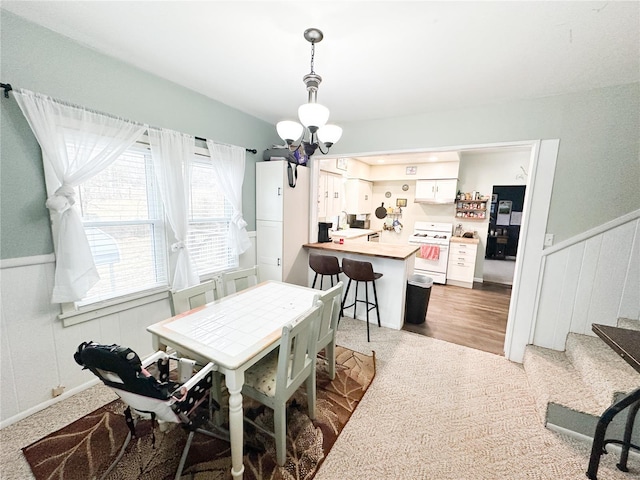 807 E 4th St, Salem, MO 65560 - dining area with a chandelier, wainscoting, stairs, and a decorative wall