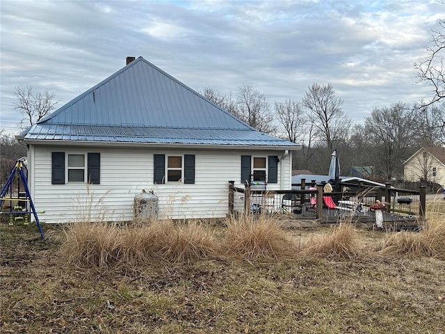 807 E 4th St, Salem, MO 65560 - back of property with metal roof, a chimney, and a wooden deck