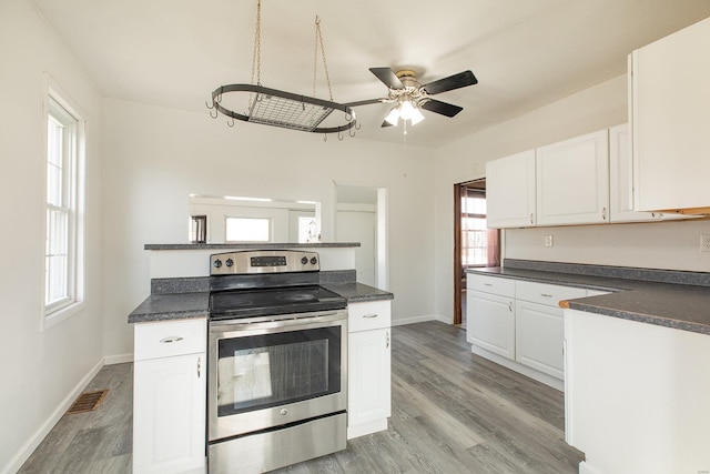 204 S Railroad St, Medora, IL 62063 - kitchen featuring stainless steel electric range, dark countertops, a ceiling fan, and white cabinets