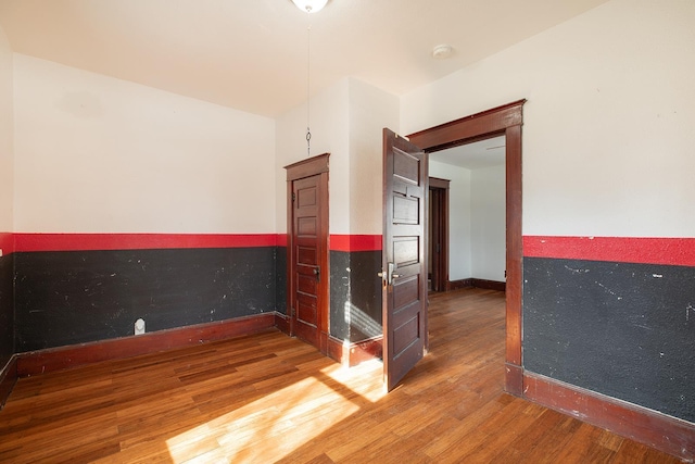 204 S Railroad St, Medora, IL 62063 - empty room with wood finished floors, a smoke detector, and baseboards